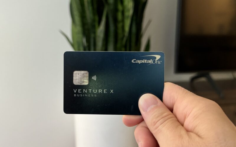 Nomadic Matt holding up his Capital One Venture X business card